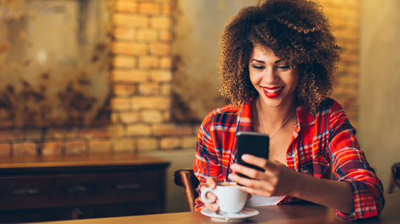 woman on phone with coffee